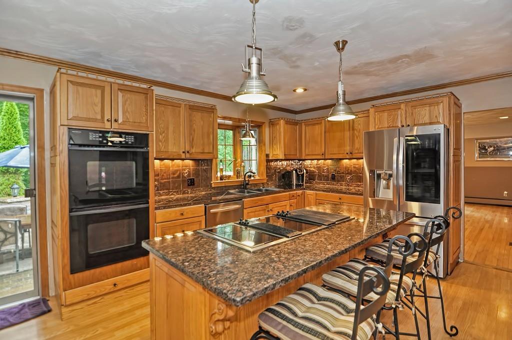 38 Johnson Road Sutton, MA 01590 - Photo 7 of 42 a kitchen with stainless steel appliances granite countertop a sink a stove and a refrigerator