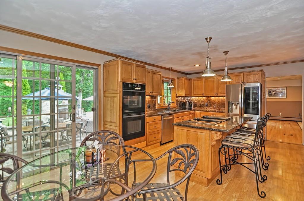 38 Johnson Road Sutton, MA 01590 - Photo 8 of 42 a kitchen with stainless steel appliances wooden floor dining table and chairs