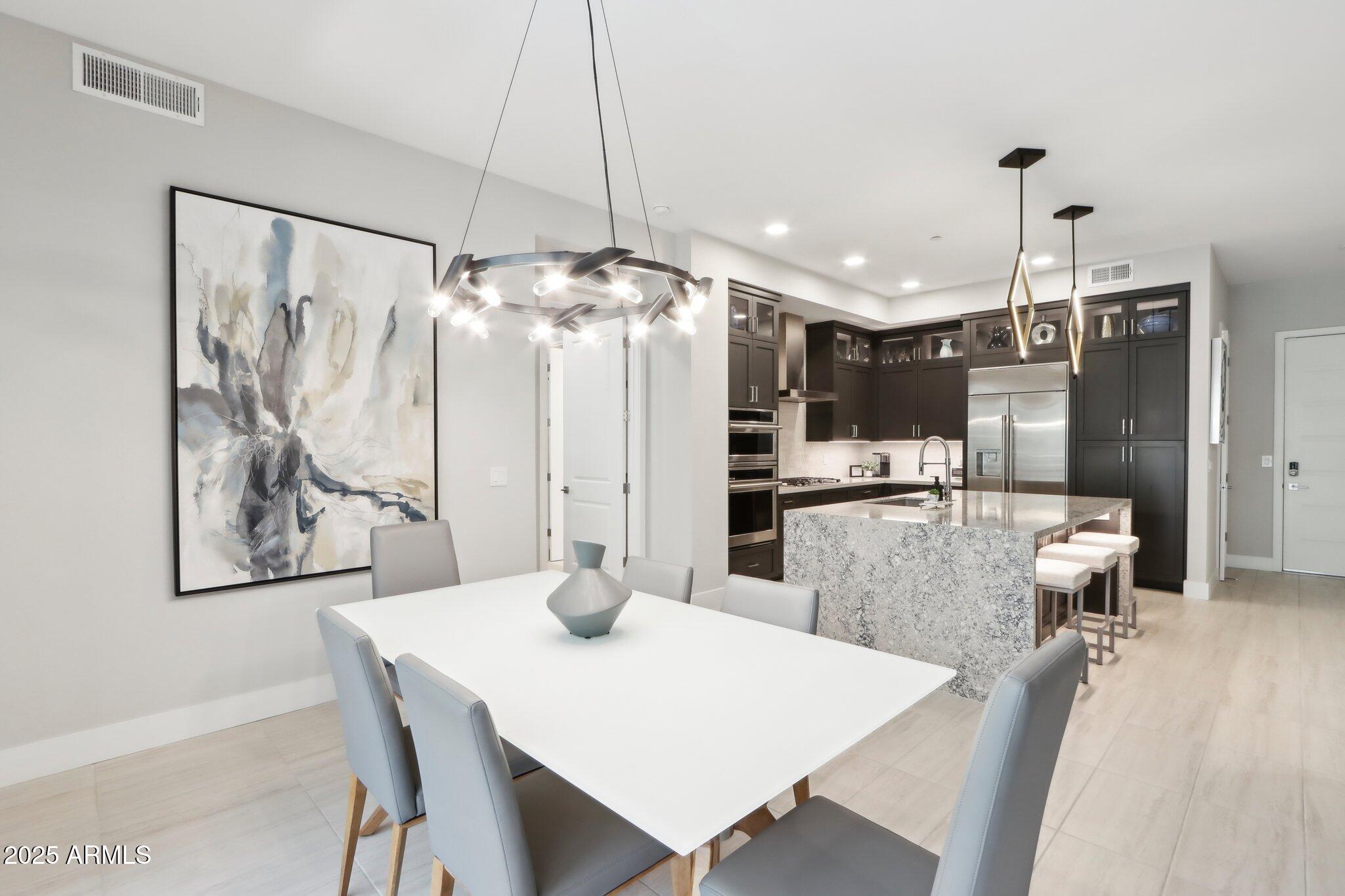 5250 East Deer Valley Drive, Unit 247 Phoenix, AZ 85054 - Photo 10 of 56 a kitchen with a table and chairs