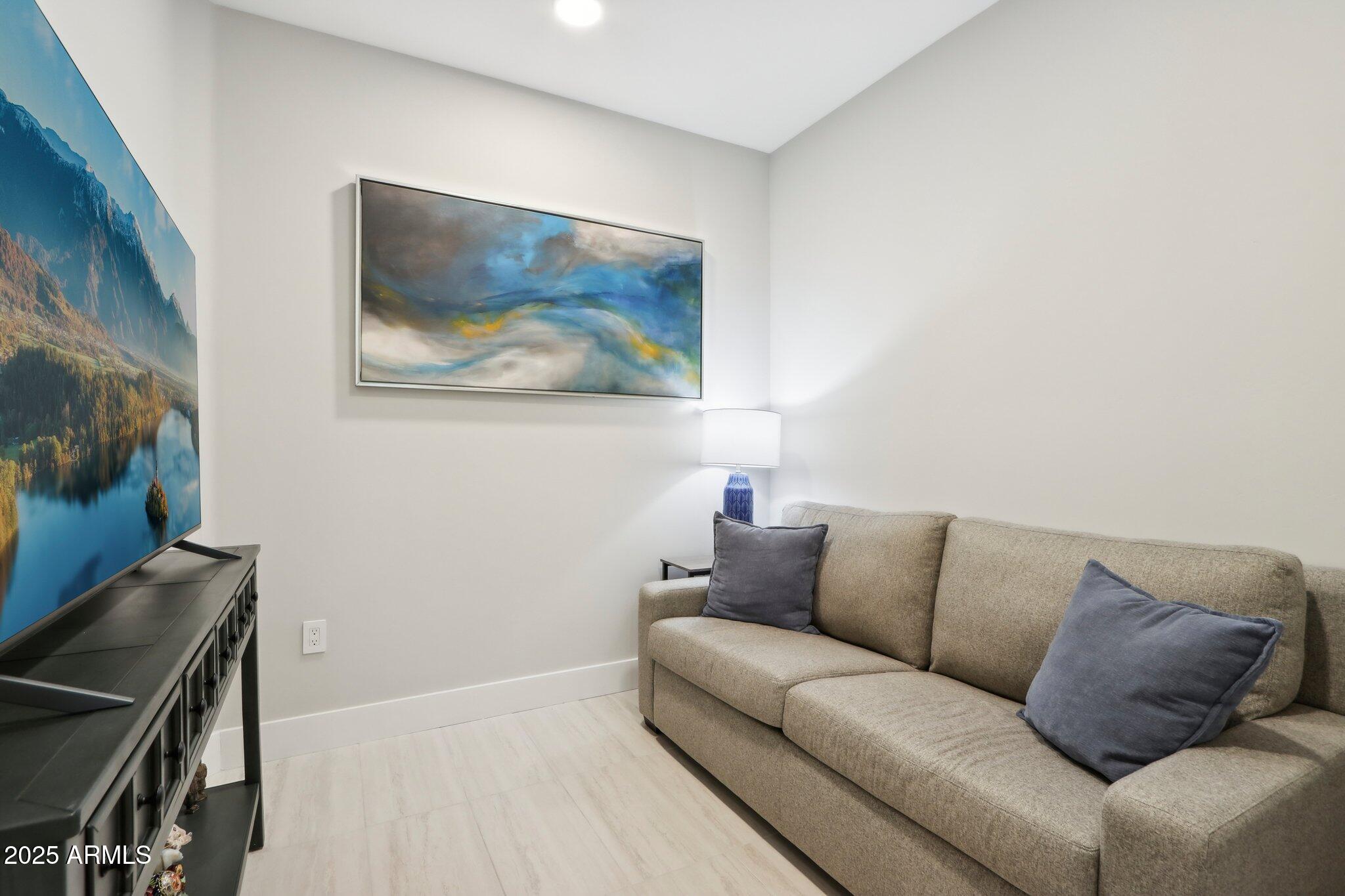 5250 East Deer Valley Drive, Unit 247 Phoenix, AZ 85054 - Photo 12 of 56 a living room with furniture and a flat screen tv