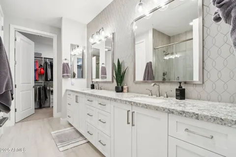 a large bed sitting in a bedroom next to a window