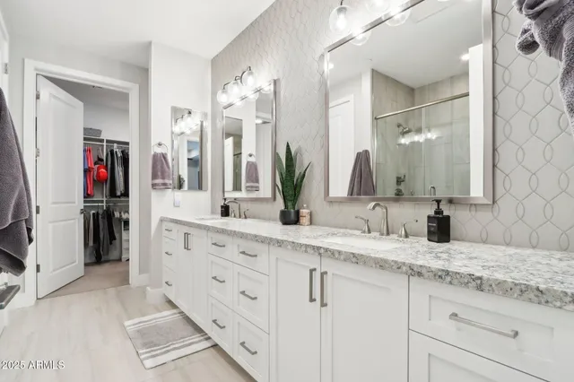 a large bed sitting in a bedroom next to a window