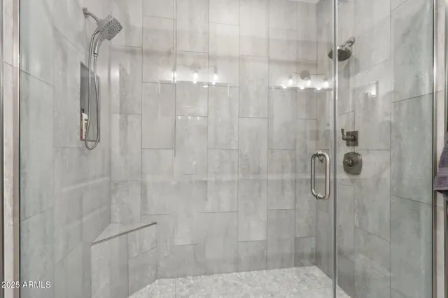 a bathroom with a granite countertop sink a mirror and a shower