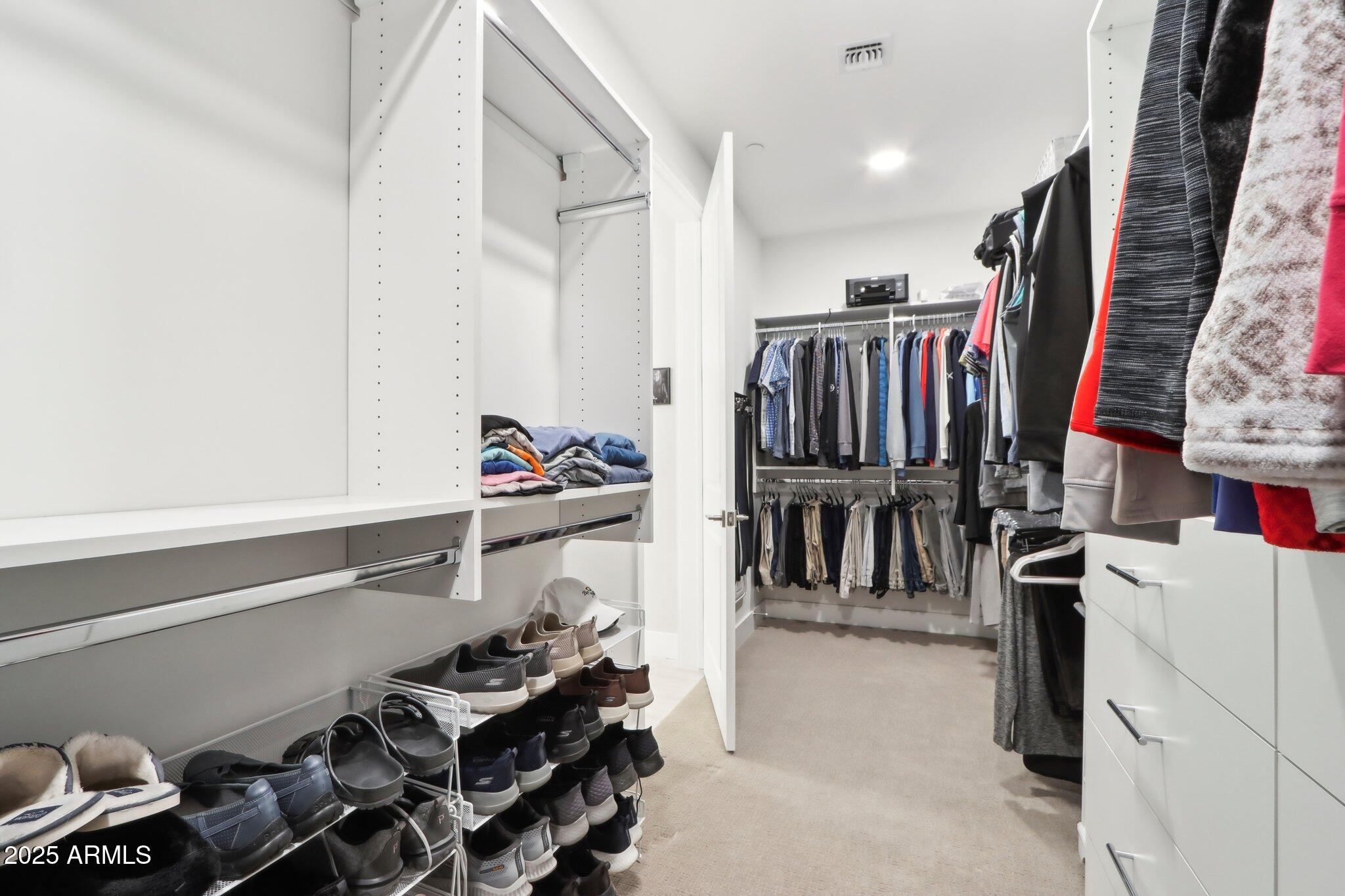 5250 East Deer Valley Drive, Unit 247 Phoenix, AZ 85054 - Photo 20 of 56 a view of walk in closet with clothes and shoes