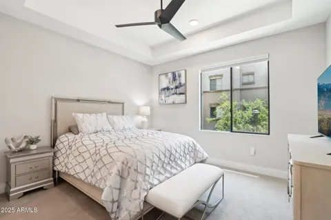 a bedroom with a large bed and a flat screen tv