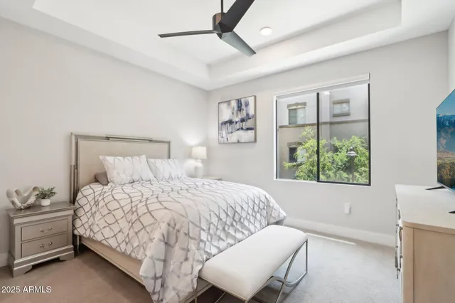 a bedroom with a large bed and a flat screen tv