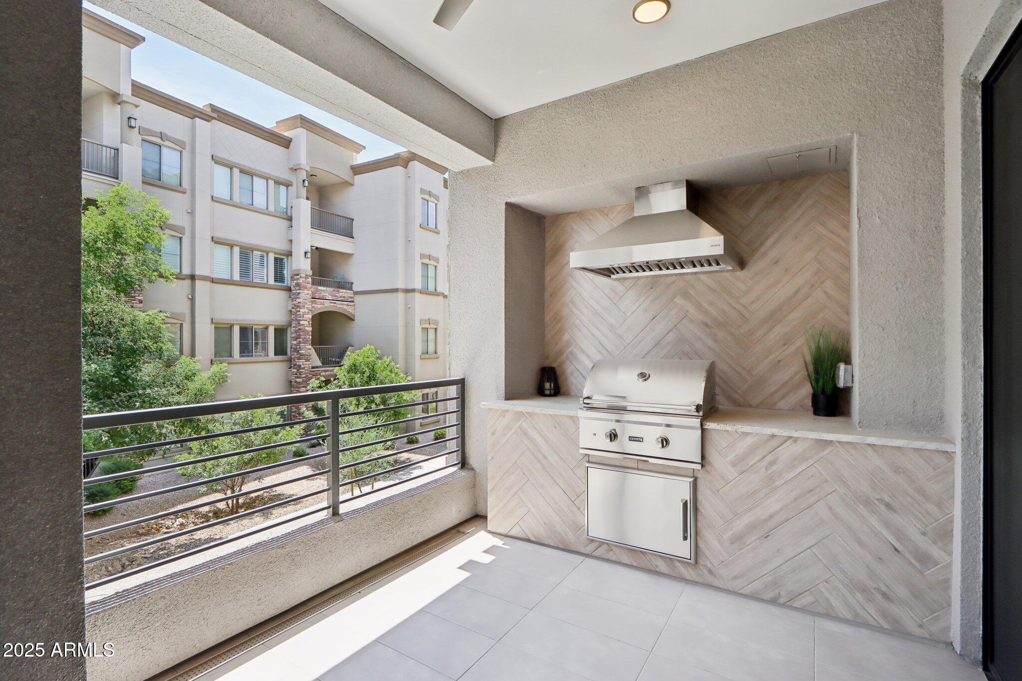 5250 East Deer Valley Drive, Unit 247 Phoenix, AZ 85054 - Photo 28 of 56 a kitchen with white cabinets and a stove