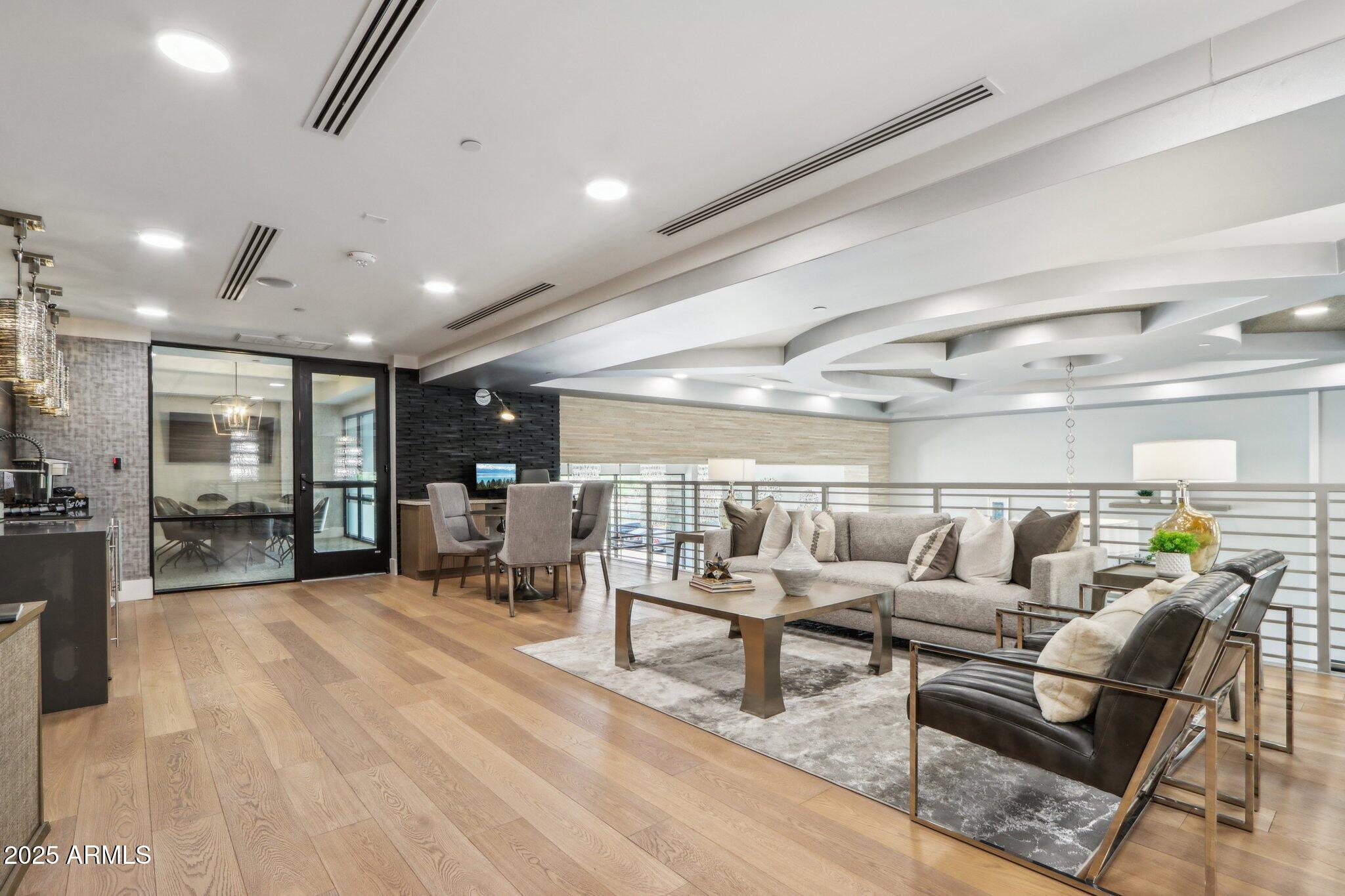 5250 East Deer Valley Drive, Unit 247 Phoenix, AZ 85054 - Photo 30 of 56 a living room with lots of furniture and a table