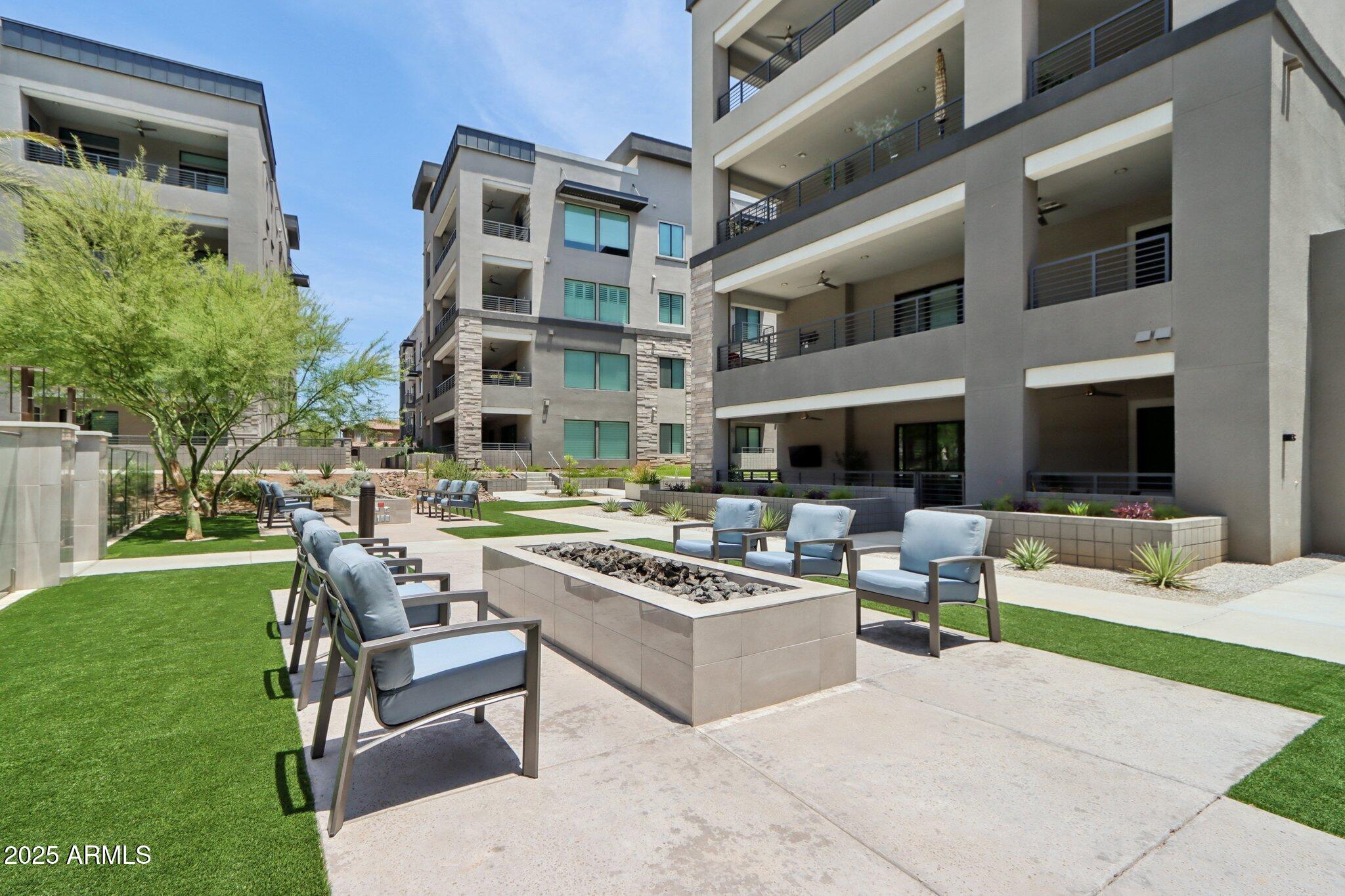 5250 East Deer Valley Drive, Unit 247 Phoenix, AZ 85054 - Photo 43 of 56 a view of a building and couches in the patio