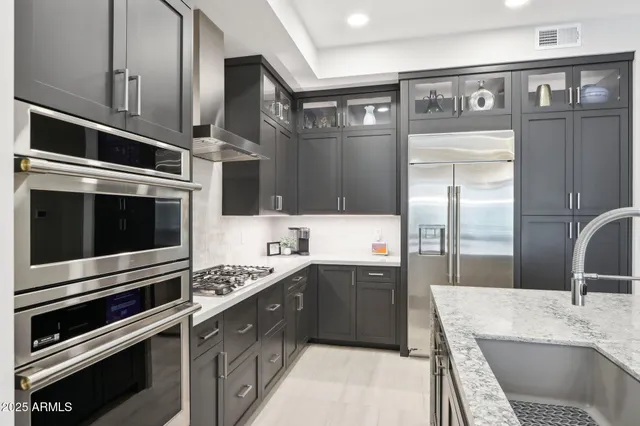 a large kitchen with lots of counter space and furniture