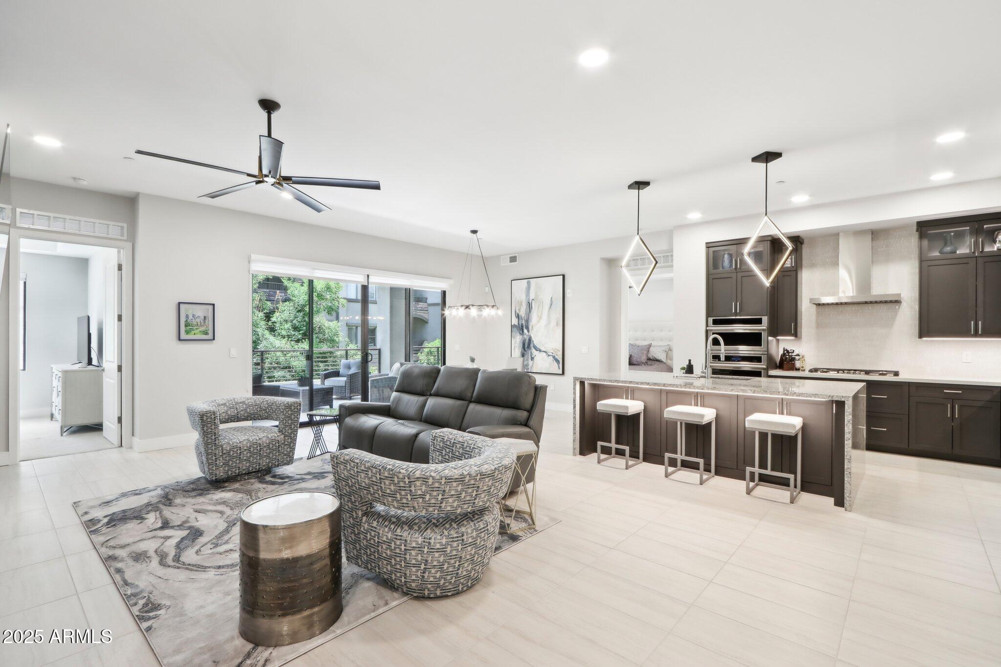 5250 East Deer Valley Drive, Unit 247 Phoenix, AZ 85054 - Photo 54 of 56 a living room with furniture kitchen view and a large window