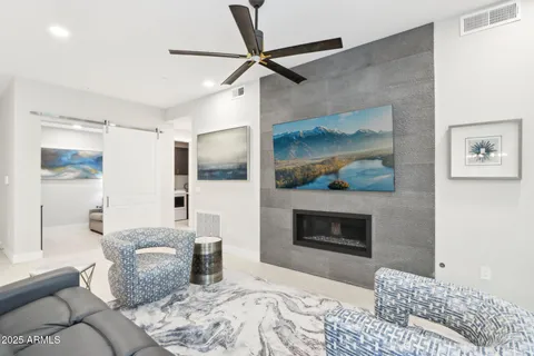 a living room with furniture and kitchen view