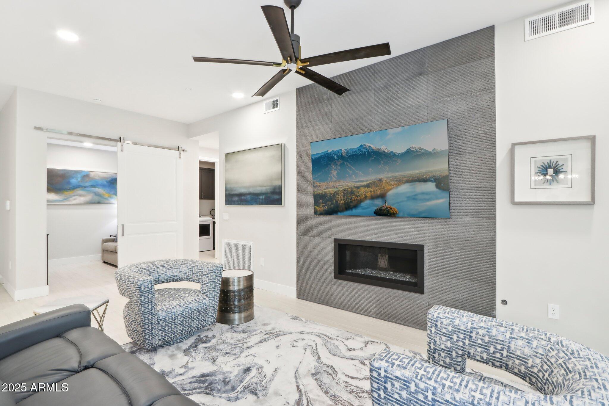 5250 East Deer Valley Drive, Unit 247 Phoenix, AZ 85054 - Photo 7 of 56 a bedroom with furniture and a fireplace