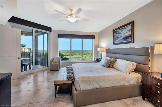 a bedroom with a bed and glass windows
