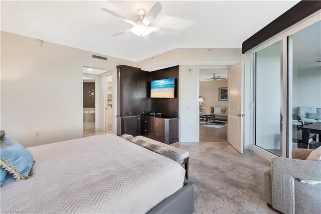 a large bedroom with a bed and a television in it