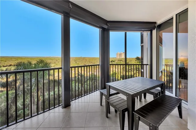 a living room with furniture chandelier and a large window