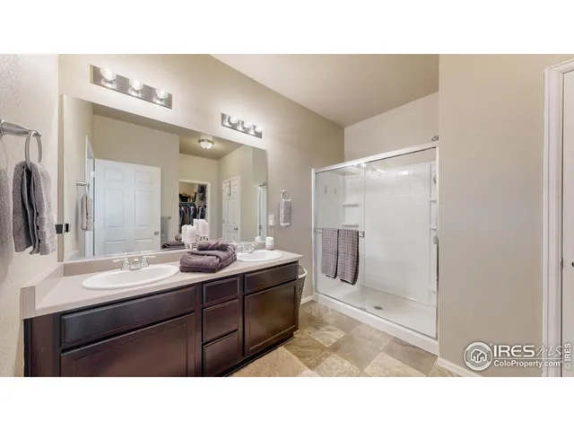 a bathroom with a sink mirror and shower