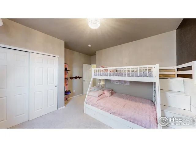 a living room with a bed furniture and a walk in closet
