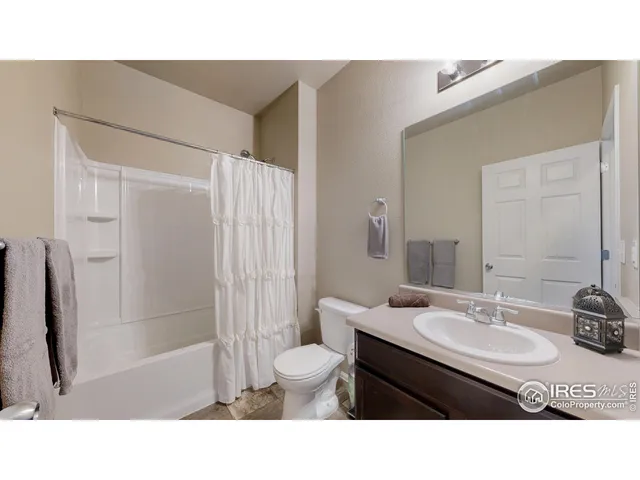 a bathroom with a sink double vanity granite tub shower and a mirror