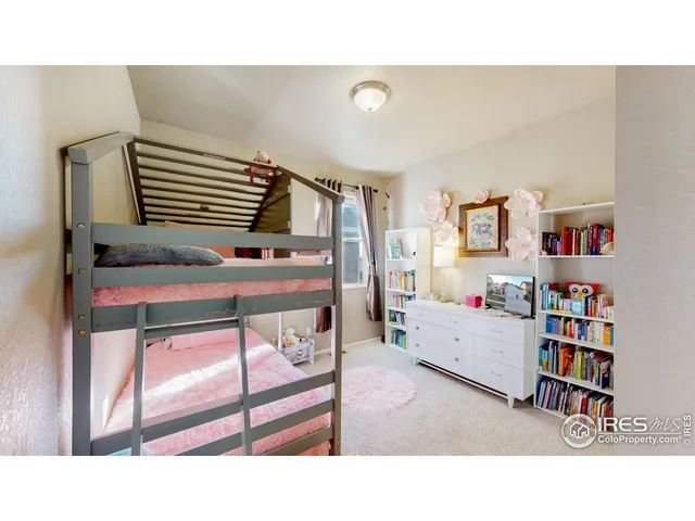 a living room with furniture and a book shelf