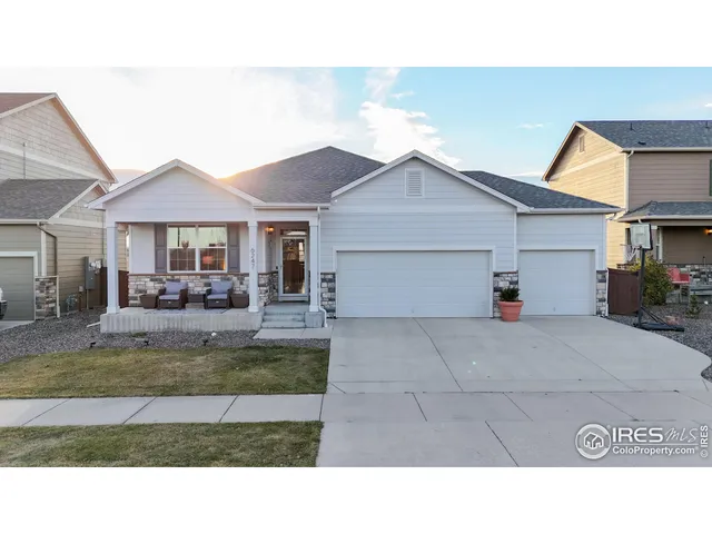 a house view with a seating space and a garden