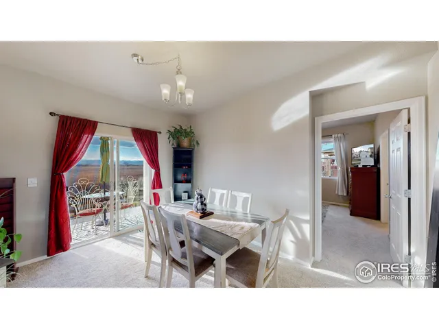 a living room with furniture a window and a flat screen tv
