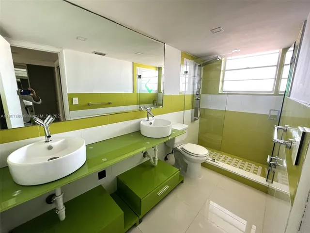 a bathroom with a toilet a sink and a window