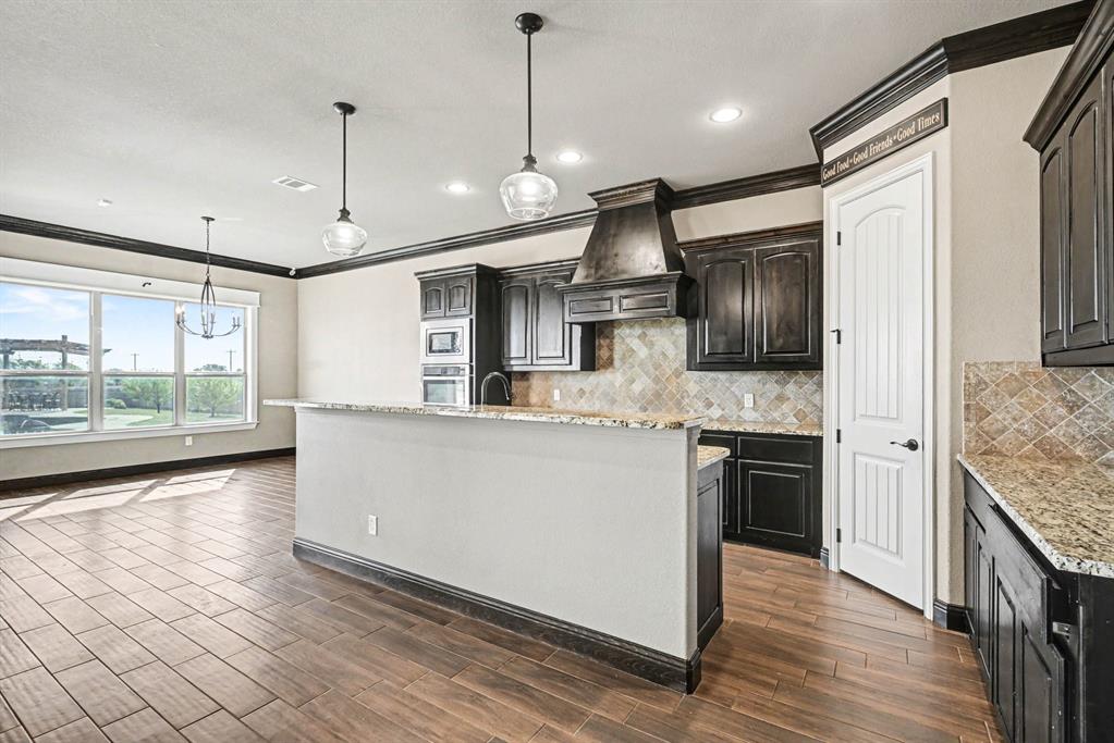 104 Stanford Lane Springtown, TX 76082 - Photo 6 of 28 a large kitchen with stainless steel appliances granite countertop a stove a sink and a refrigerator