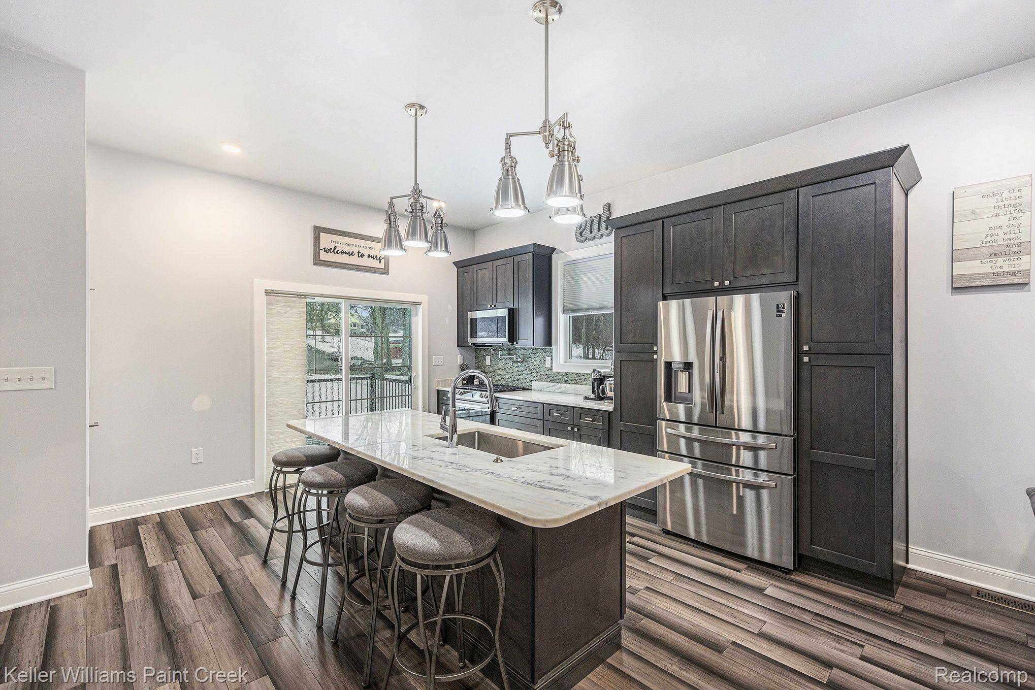 1310 Trio Hill Road Leonard, MI 48367 - Photo 5 of 26 Kitchen with quartz counters & Samsung appliances.