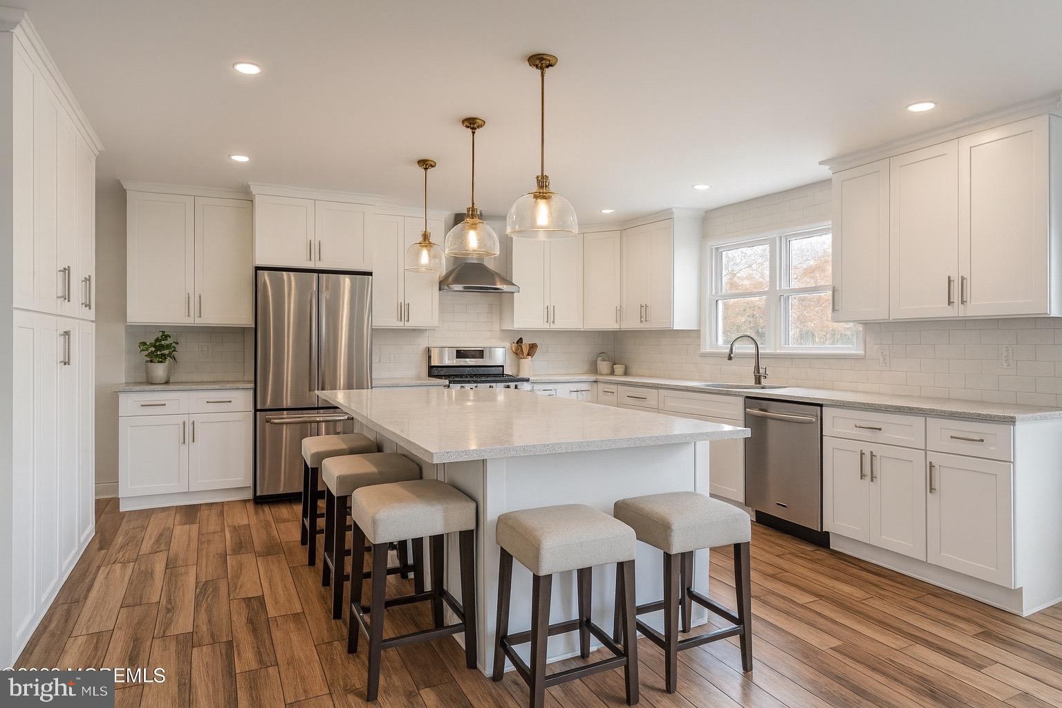 8 Inman Road New Egypt, NJ 08533 - Photo 4 of 13 a kitchen with refrigerator cabinets dining table and chairs