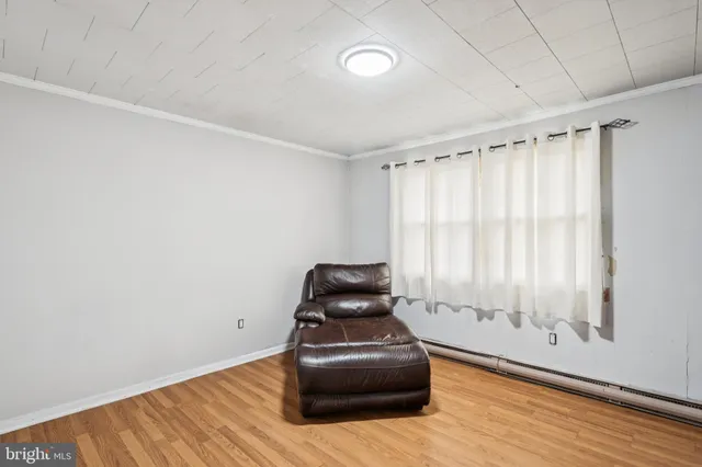 a room with a wooden floor and a window