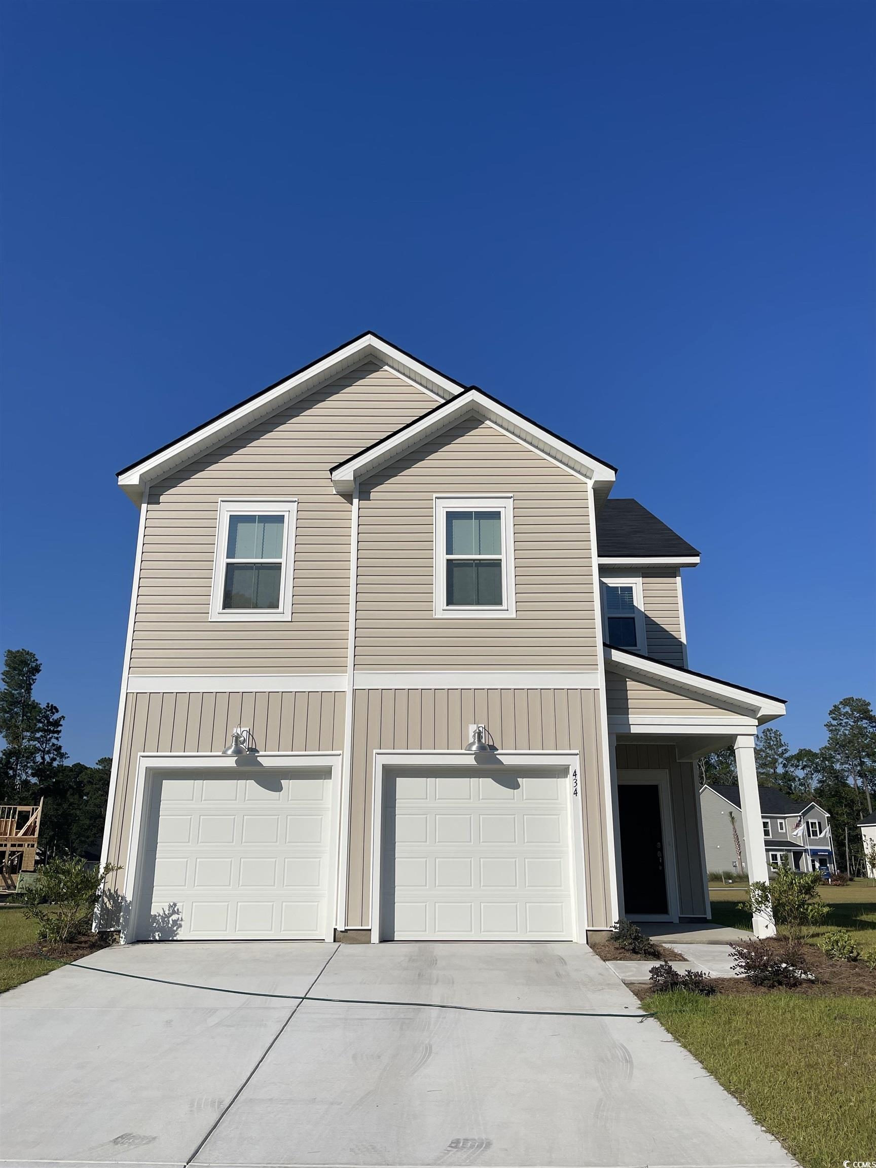 Traditional home with concrete driveway, an attach