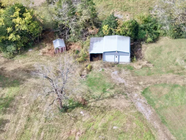 a view of a house with swimming pool and a yard