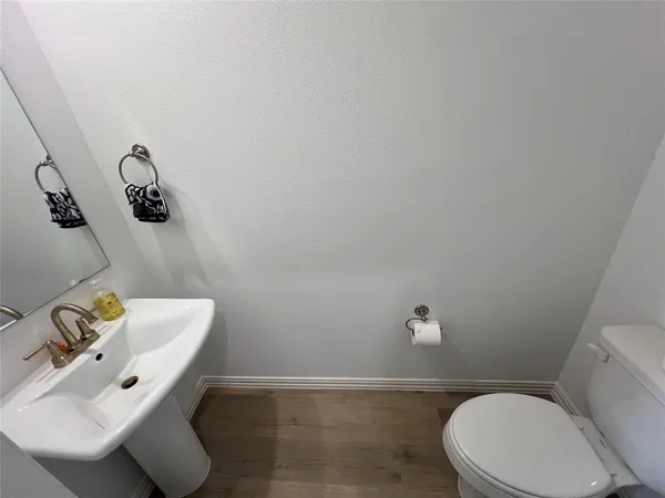 a white toilet sitting next to a bathroom sink