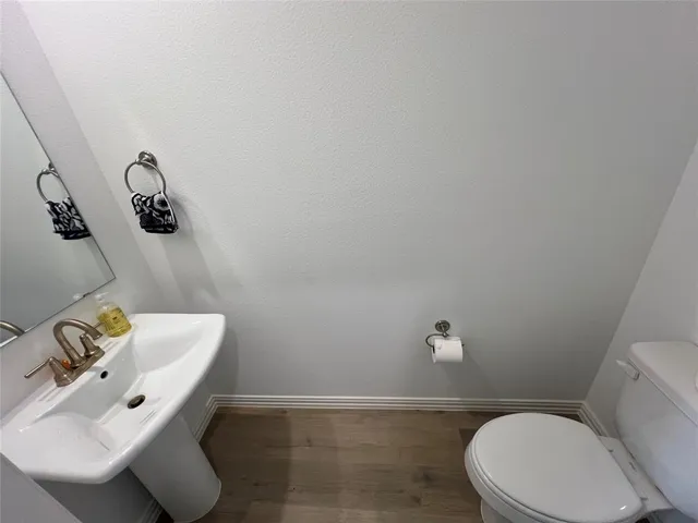 a white toilet sitting next to a bathroom sink