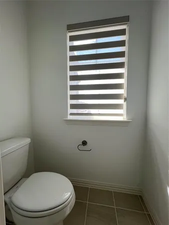 a white toilet sitting next to a window