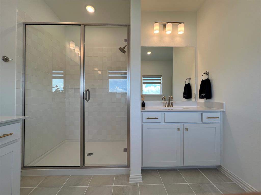 2616 Rolling Mdw Road Celina, TX 75009 - Photo 22 of 35 Bathroom featuring vanity, a stall shower, light tile patterned floors, and recessed lighting