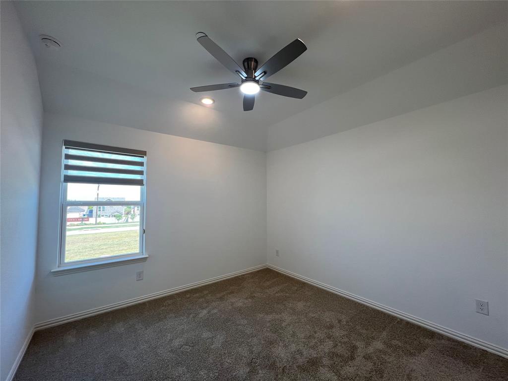2616 Rolling Mdw Road Celina, TX 75009 - Photo 26 of 35 Spare room featuring dark colored carpet, a ceiling fan, and recessed lighting
