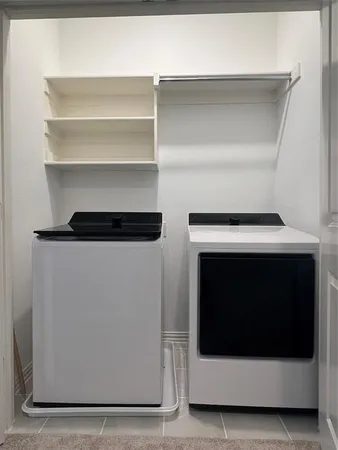 a utility room with washer and dryer