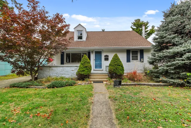 a view of a house with yard and tree s
