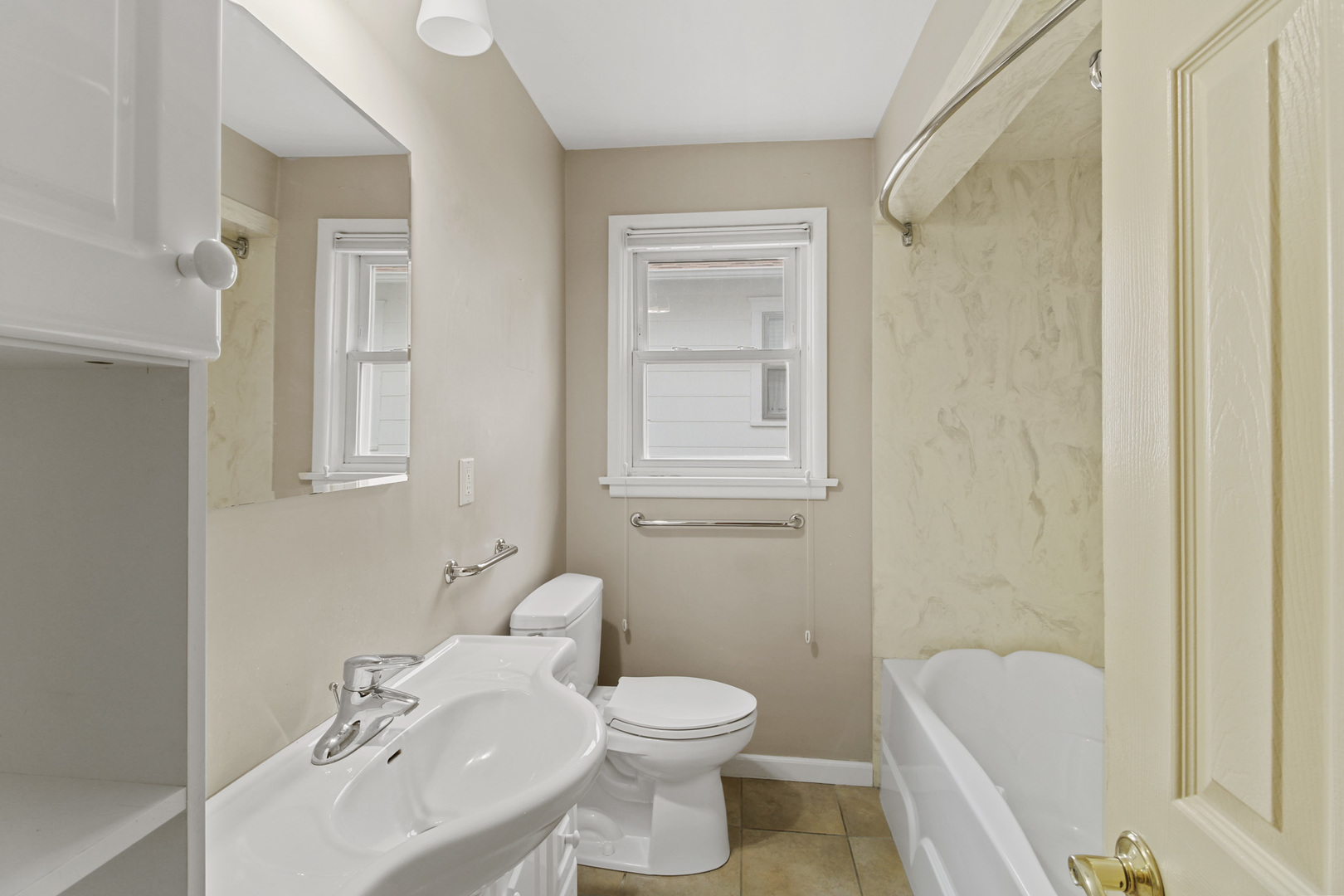 1208 West William Street Champaign, IL 61821 - Photo 14 of 30 a bathroom with a sink toilet and shower