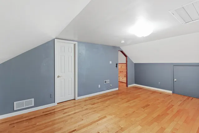 a view of a big room with closet and wooden floor