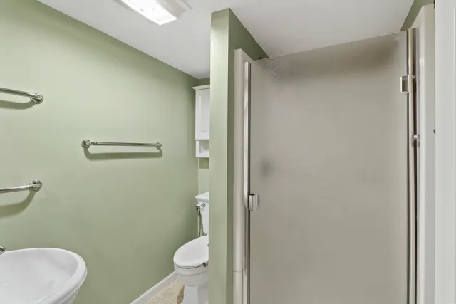 a bathroom with a granite countertop toilet and a sink