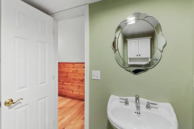 a bathroom with a mirror and a sink