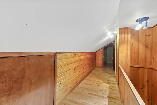 a view of room with wooden floor and staircase