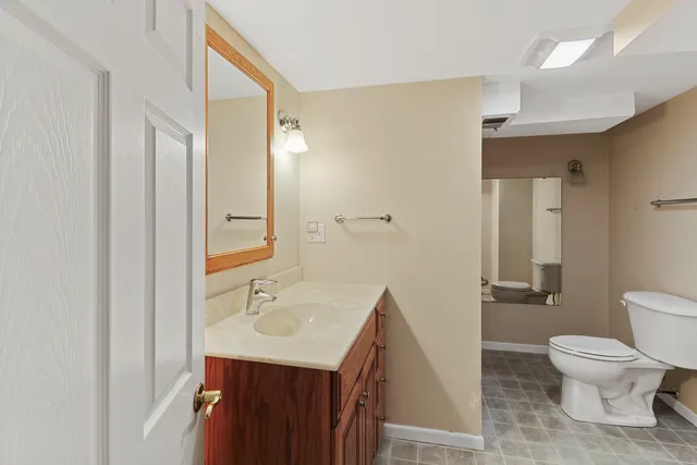 a bathroom with a toilet a sink and shower