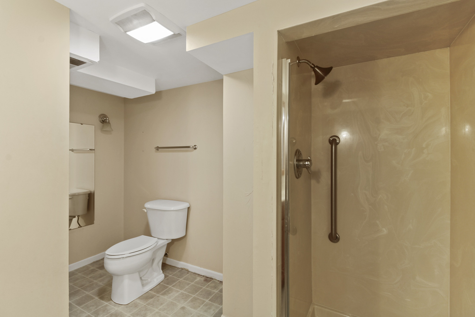 1208 West William Street Champaign, IL 61821 - Photo 26 of 30 a bathroom with a toilet a sink and shower