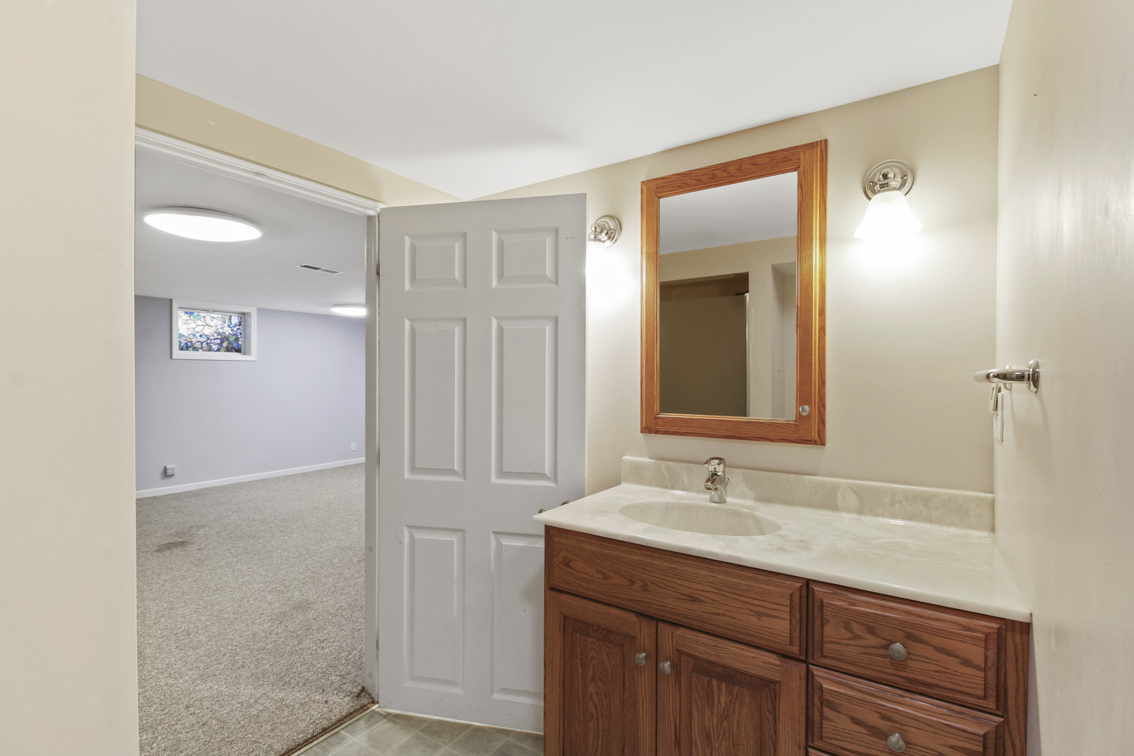 1208 West William Street Champaign, IL 61821 - Photo 27 of 30 a bathroom with a granite countertop sink and a mirror