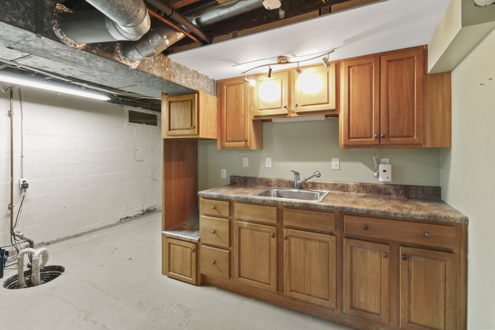 1208 West William Street Champaign, IL 61821 - Photo 28 of 30 a kitchen with a sink cabinets and window