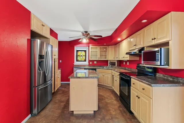 a kitchen that has a lot of cabinets in it